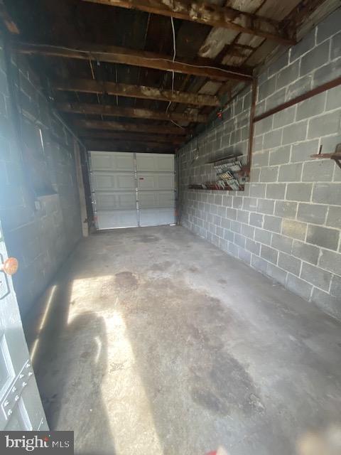 garage with concrete block wall