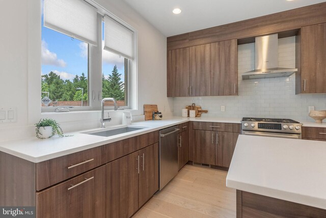 740 S Columbus Blvd Unit 74, Philadelphia, PA 19147 - kitchen with wall chimney range hood, stainless steel appliances, light countertops, backsplash, and recessed lighting