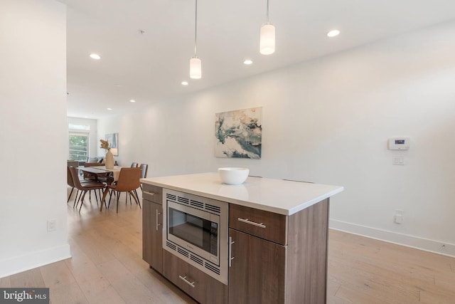 740 S Columbus Blvd Unit 74, Philadelphia, PA 19147 - kitchen with stainless steel microwave, modern cabinets, light wood-type flooring, pendant lighting, and recessed lighting