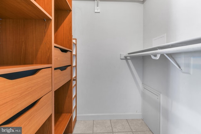 walk in closet featuring light tile patterned flooring