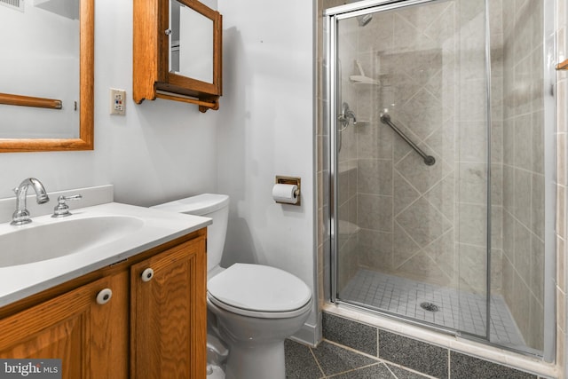 full bath featuring vanity, a stall shower, and toilet
