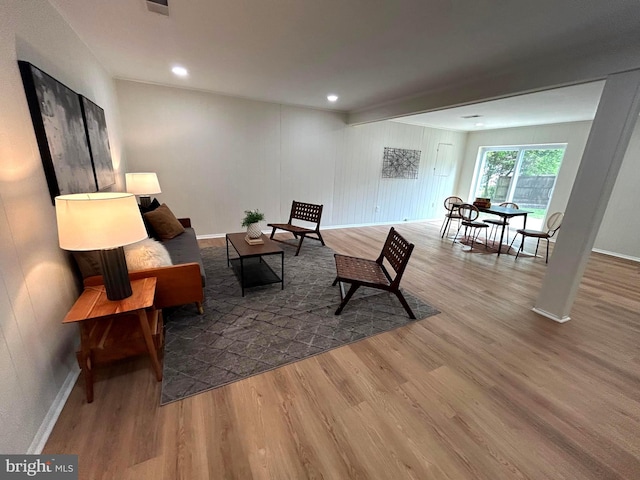 living area featuring baseboards, recessed lighting, and wood finished floors