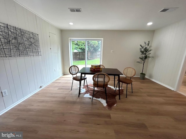 dining area with visible vents, wood finished floors, and baseboards