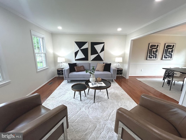 living room with recessed lighting, crown molding, visible vents, and wood finished floors