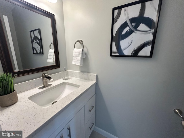 bathroom with baseboards and vanity