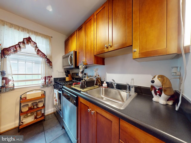 4408 1st Pl NE Unit 14, Washington, DC 20011 - kitchen with appliances with stainless steel finishes, a sink, brown cabinets, dark tile patterned flooring, and dark countertops