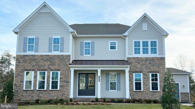 15595 Cloverland Ln, Haymarket, VA 20169 - view of front facade featuring covered porch, a standing seam roof, metal roof, a front lawn, and stone siding