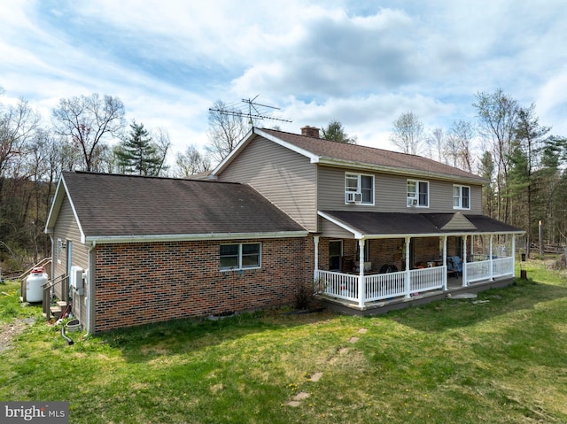 505 Deibler Rd, Pennsylvania Furnace, PA 16865 - rear view of house with a porch, brick siding, a yard, and a chimney