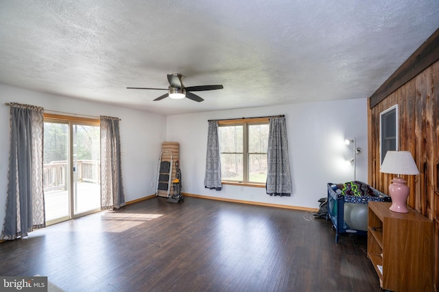 505 Deibler Rd, Pennsylvania Furnace, PA 16865 - interior space with ceiling fan, a textured ceiling, wood finished floors, baseboards, and wooden walls