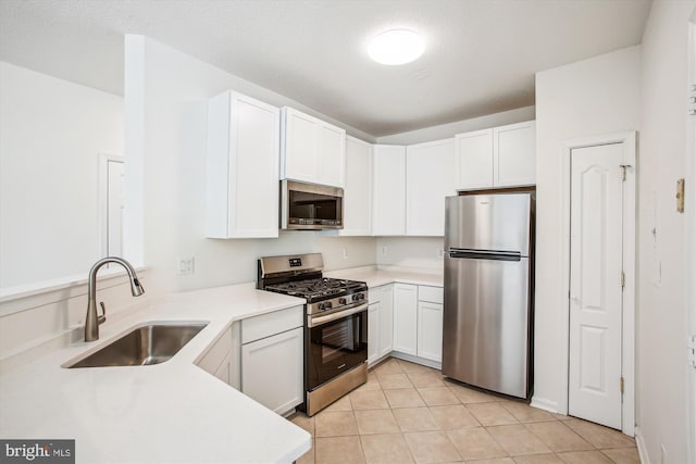 1704 Lake Shore Crest Dr Unit 32, Reston, VA 20190 - kitchen with appliances with stainless steel finishes, a sink, light countertops, and white cabinetry