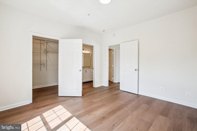 1704 Lake Shore Crest Dr Unit 32, Reston, VA 20190 - unfurnished bedroom with wood finished floors, baseboards, a closet, and a spacious closet