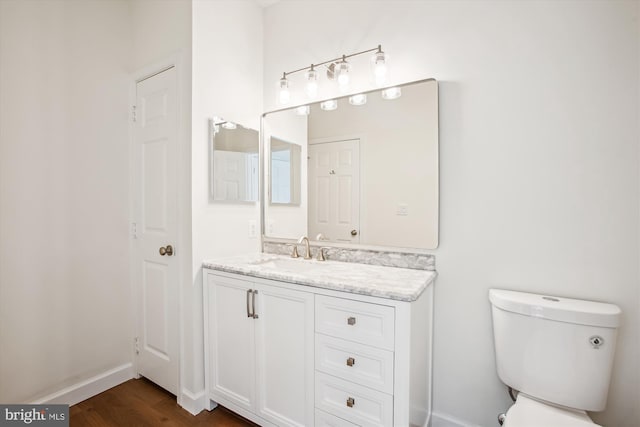 1704 Lake Shore Crest Dr Unit 32, Reston, VA 20190 - half bath featuring toilet, wood finished floors, vanity, and baseboards
