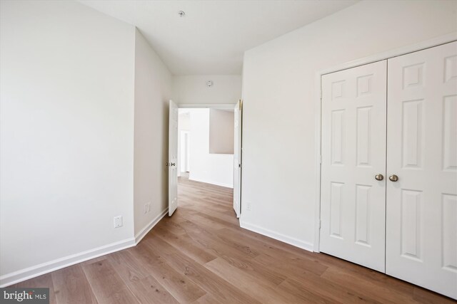 1704 Lake Shore Crest Dr Unit 32, Reston, VA 20190 - unfurnished bedroom featuring wood finished floors, baseboards, and a closet