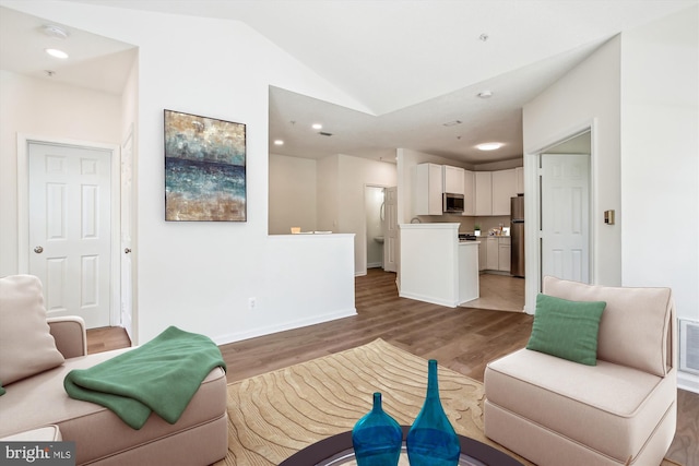 1704 Lake Shore Crest Dr Unit 32, Reston, VA 20190 - living area with light wood finished floors, vaulted ceiling, baseboards, and recessed lighting