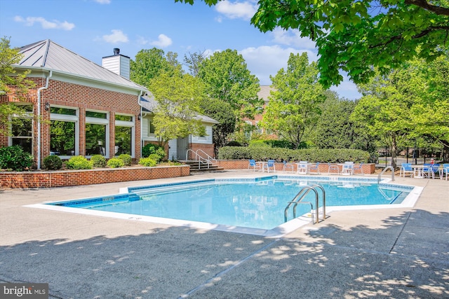 1704 Lake Shore Crest Dr Unit 32, Reston, VA 20190 - community pool featuring a patio and fence