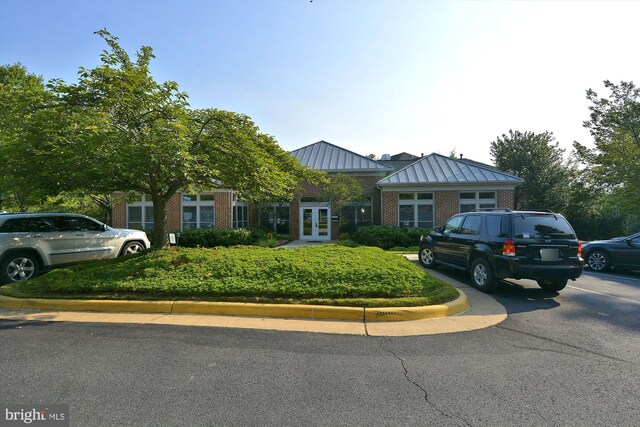 1704 Lake Shore Crest Dr Unit 32, Reston, VA 20190 - view of front of property with french doors, brick siding, a standing seam roof, and uncovered parking