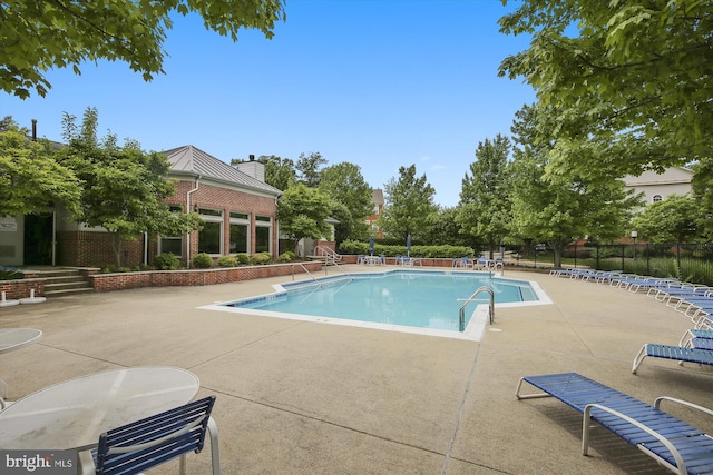 1704 Lake Shore Crest Dr Unit 32, Reston, VA 20190 - community pool with a patio and fence