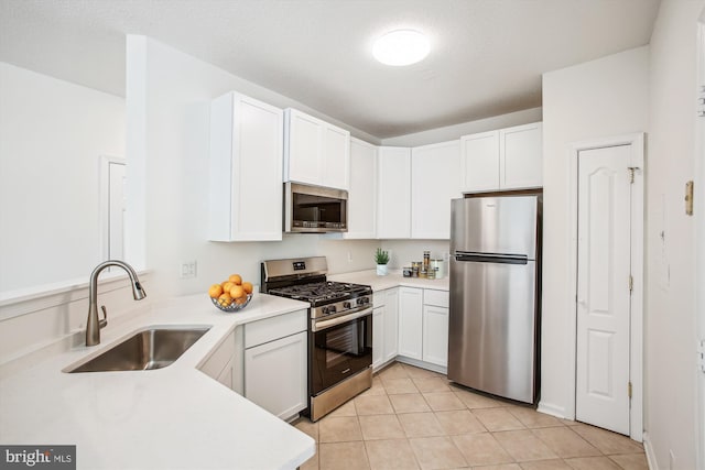 1704 Lake Shore Crest Dr Unit 32, Reston, VA 20190 - kitchen with appliances with stainless steel finishes, a sink, light countertops, and white cabinets