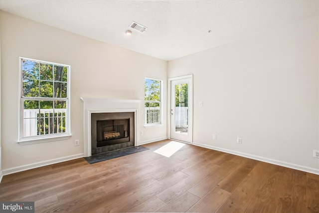 1704 Lake Shore Crest Dr Unit 32, Reston, VA 20190 - unfurnished living room featuring wood finished floors, baseboards, and a fireplace with flush hearth