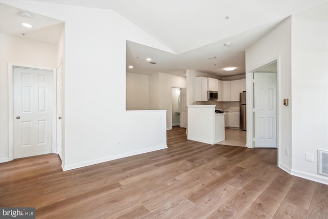 1704 Lake Shore Crest Dr Unit 32, Reston, VA 20190 - unfurnished living room with vaulted ceiling, light wood finished floors, baseboards, and recessed lighting