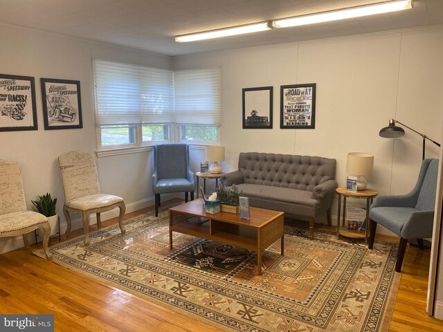 living area featuring baseboards and wood finished floors