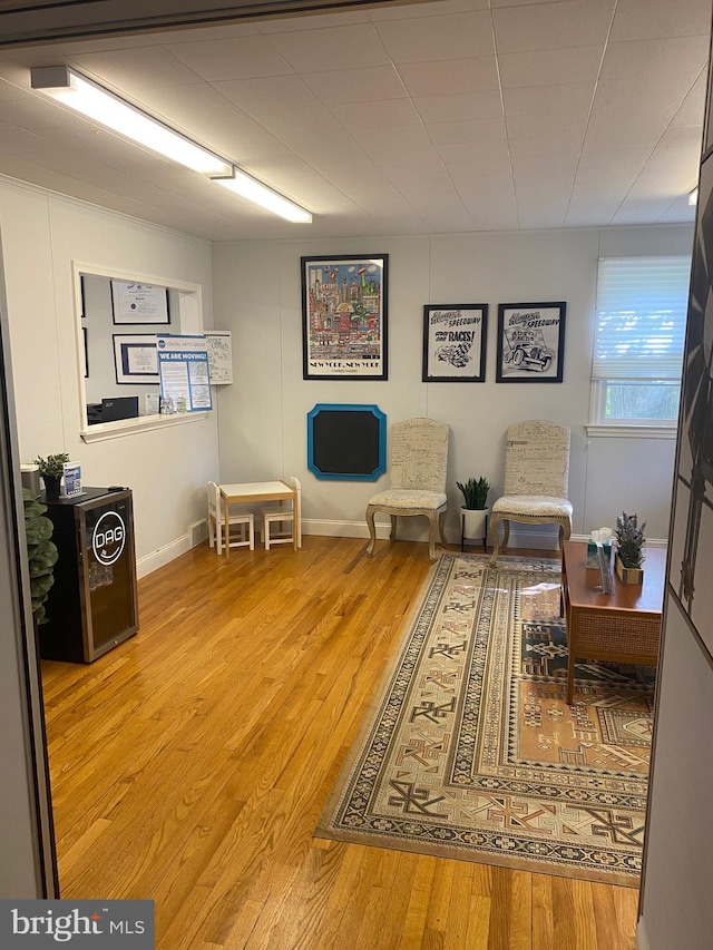 sitting room featuring baseboards and wood finished floors