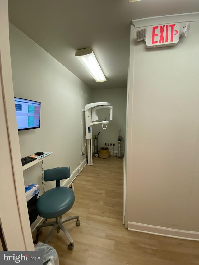 office featuring baseboards and light wood finished floors