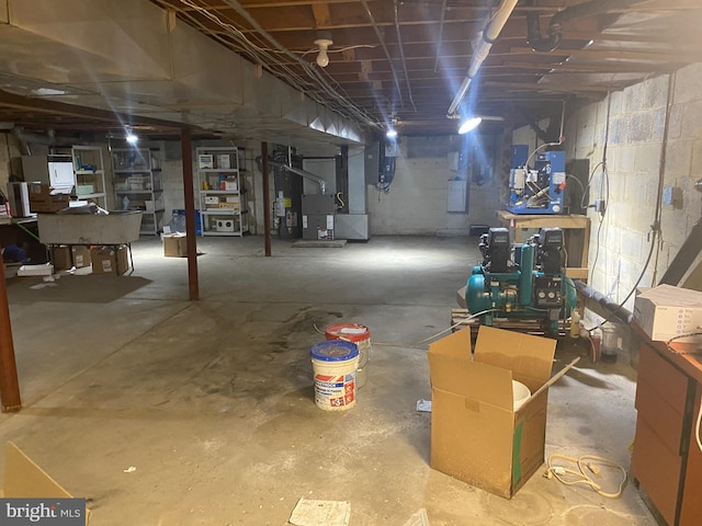 unfinished basement featuring water heater