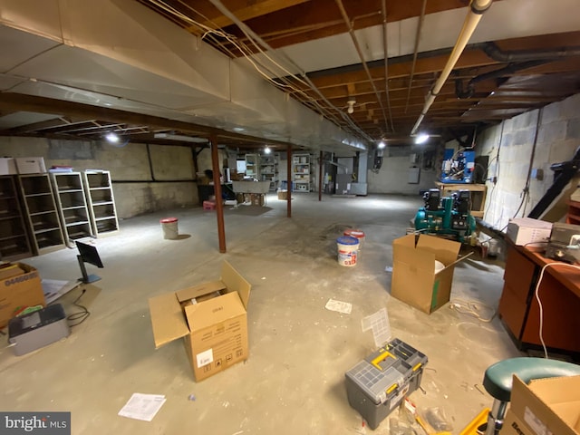 unfinished basement featuring heating unit