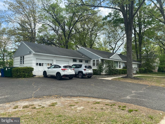 ranch-style house with driveway and a garage