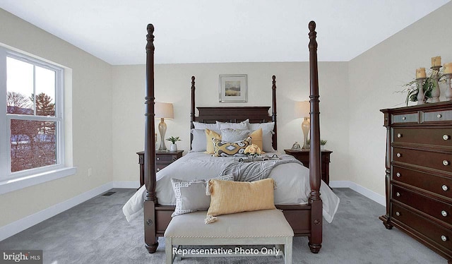carpeted bedroom featuring baseboards