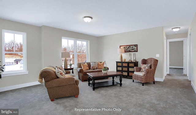 carpeted living area featuring plenty of natural light and baseboards