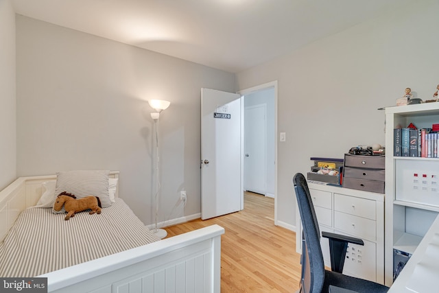 bedroom featuring baseboards and light wood-type flooring