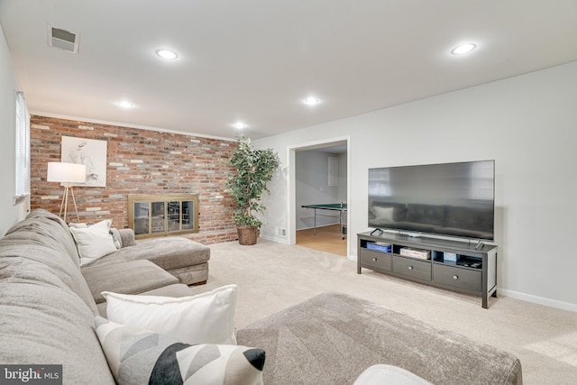 carpeted living room with recessed lighting, baseboards, visible vents, and brick wall