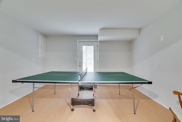 game room with baseboards and wood finished floors