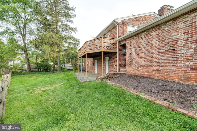 view of yard with fence, a patio, and a deck