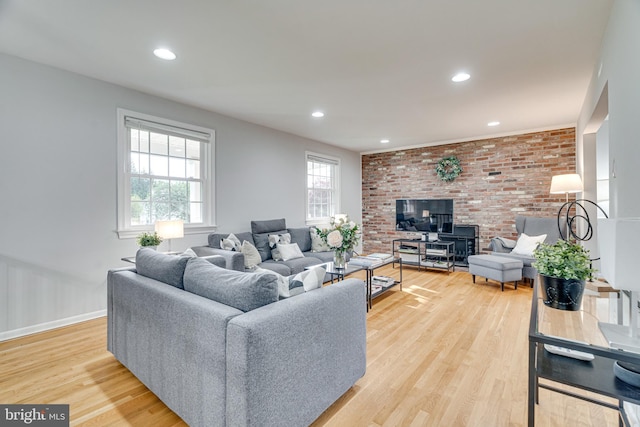 living area with recessed lighting, baseboards, a wealth of natural light, and light wood-style floors