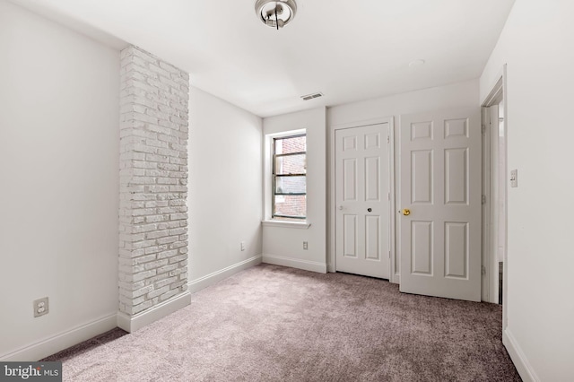 unfurnished bedroom featuring carpet floors, baseboards, and a closet