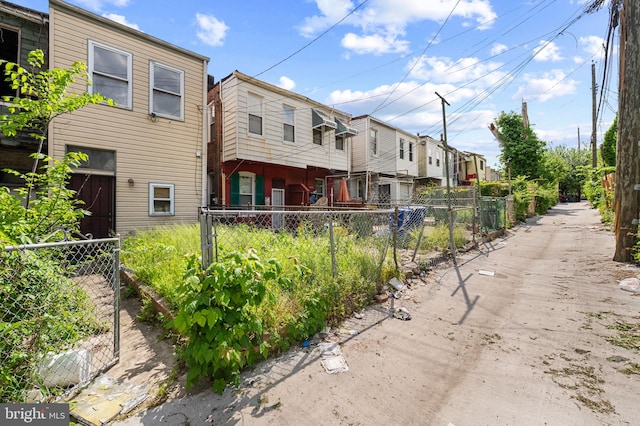 view of side of home featuring a residential view and fence