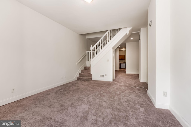 unfurnished living room featuring stairway, carpet, baseboards, and recessed lighting