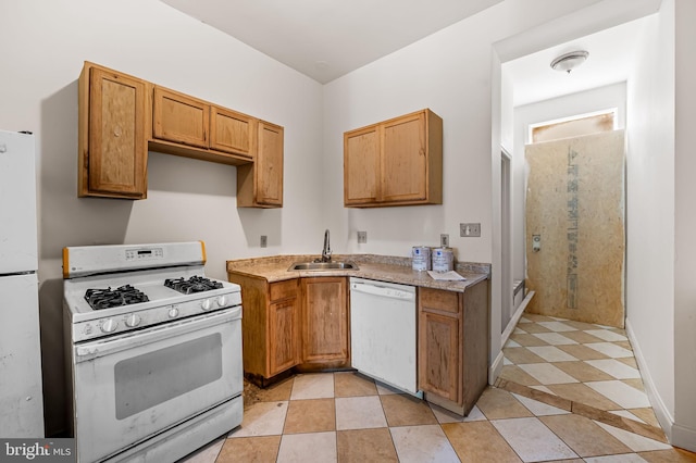 kitchen featuring white appliances, a sink, brown cabinetry, and light tile patterned flooring