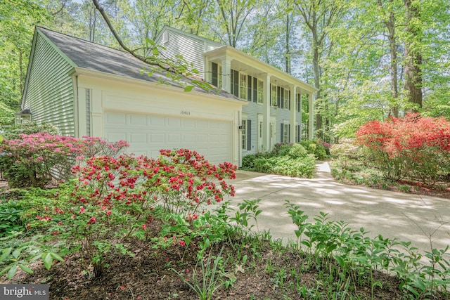 view of front facade featuring concrete driveway and an attached garage
