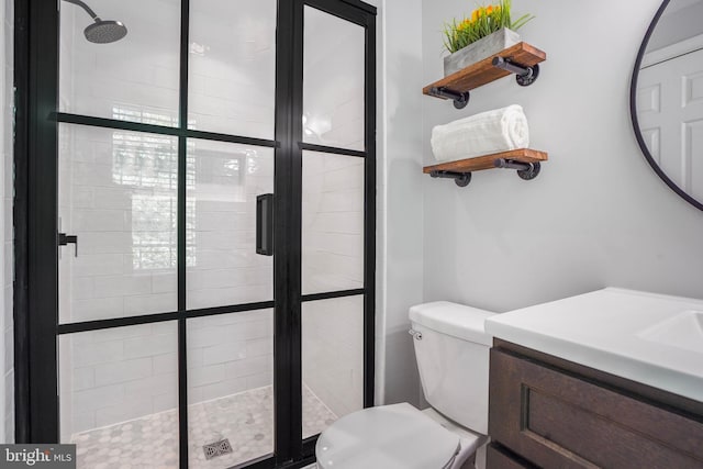 full bath with vanity, toilet, and a stall shower