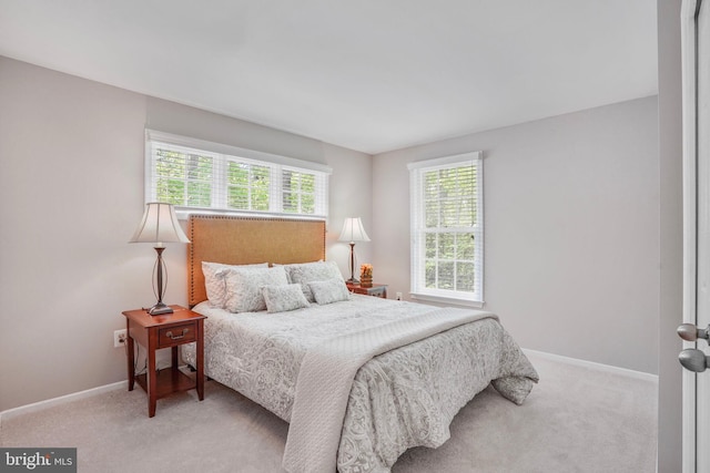 carpeted bedroom featuring baseboards