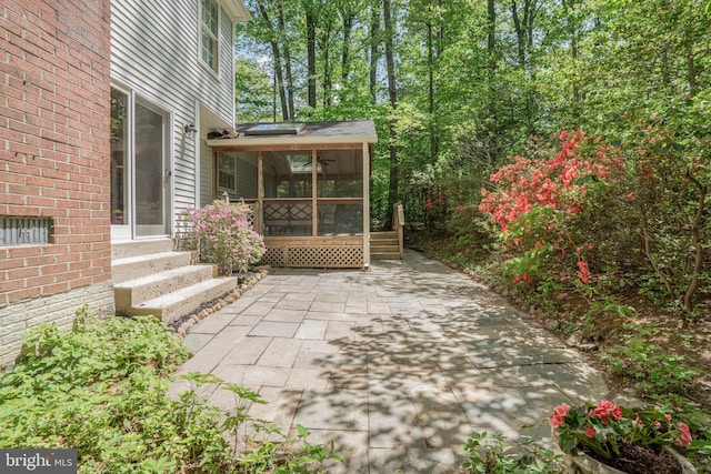 view of patio featuring entry steps and a sunroom