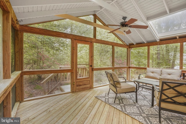 sunroom / solarium featuring a skylight, ceiling fan, and an outdoor hangout area