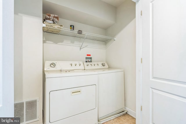 washroom with washer and dryer and visible vents