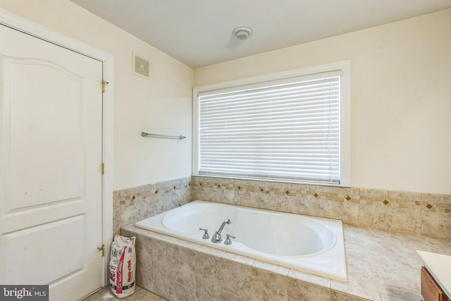 full bathroom featuring a garden tub and visible vents
