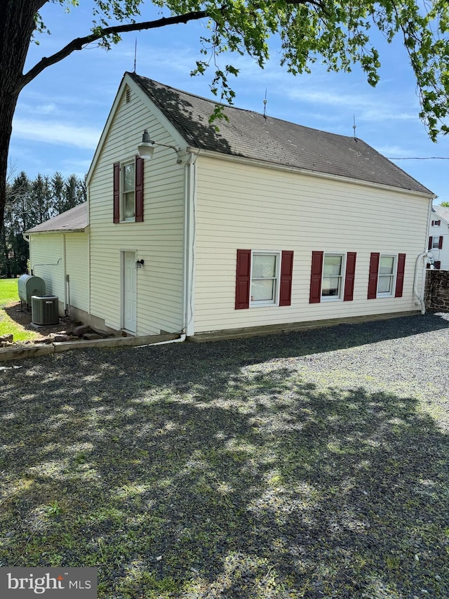rear view of property featuring central AC unit
