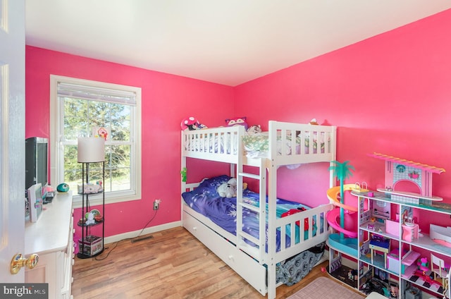 bedroom featuring baseboards and wood finished floors